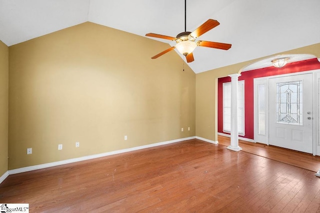 foyer with hardwood / wood-style floors, ceiling fan, lofted ceiling, and decorative columns