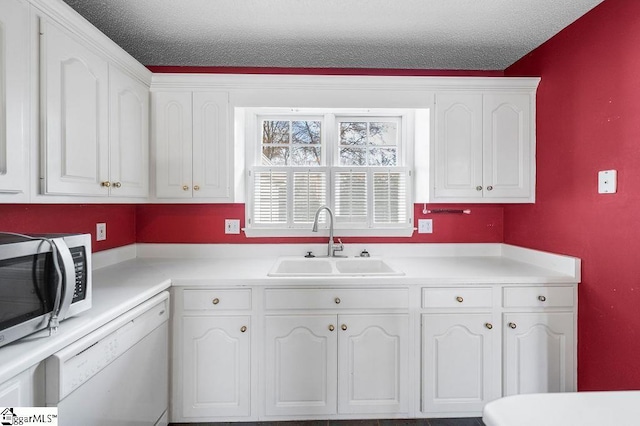 kitchen with white cabinets, a textured ceiling, white dishwasher, and sink