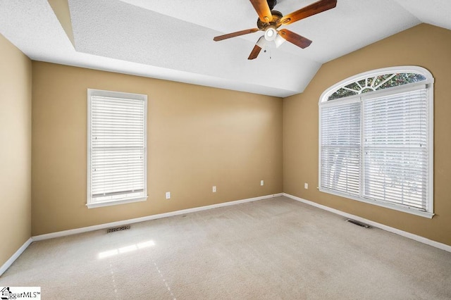 unfurnished room with ceiling fan, light colored carpet, and vaulted ceiling