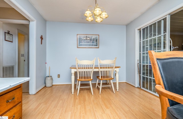 249 Monroe Bridge Rd, Honea Path, SC 29654 - dining area featuring light wood-type flooring and an inviting chandelier