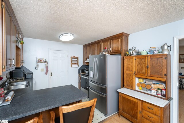 249 Monroe Bridge Rd, Honea Path, SC 29654 - kitchen featuring sink, stainless steel appliances, a textured ceiling, and light hardwood / wood-style flooring