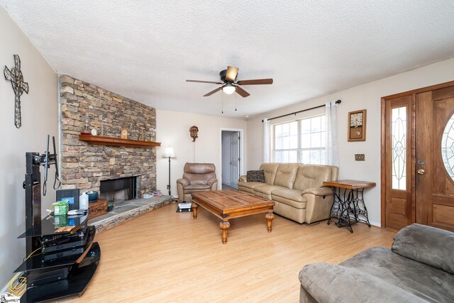 249 Monroe Bridge Rd, Honea Path, SC 29654 - living room with ceiling fan, a fireplace, a textured ceiling, and light wood-type flooring