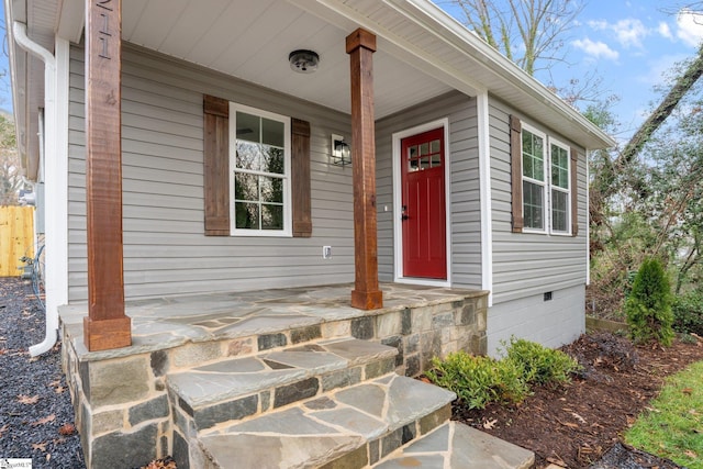 view of exterior entry featuring a porch