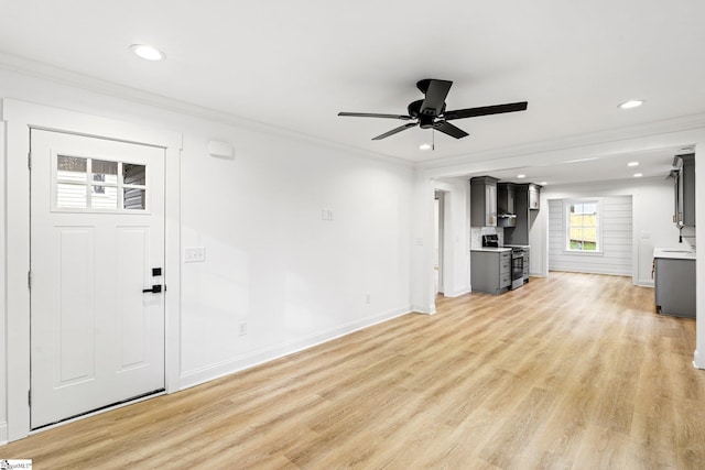 unfurnished living room with crown molding, light hardwood / wood-style flooring, and ceiling fan