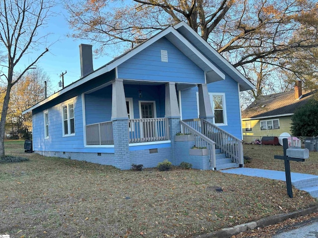 bungalow with a porch and a front yard