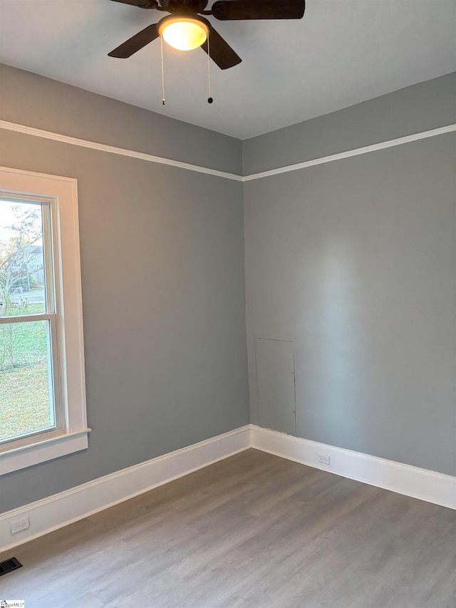 empty room with ceiling fan and wood-type flooring