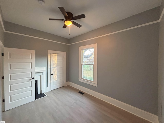 unfurnished bedroom featuring light hardwood / wood-style flooring and ceiling fan