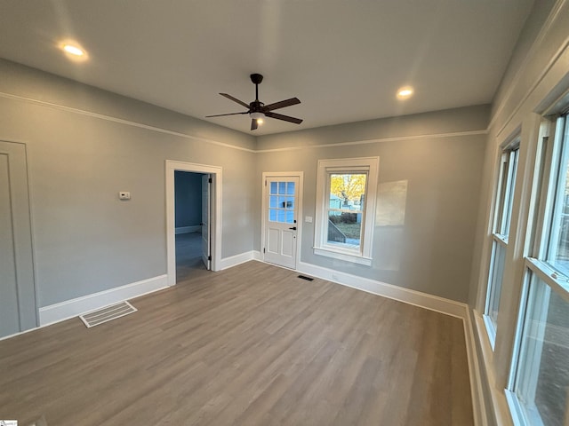 unfurnished room with ceiling fan and wood-type flooring