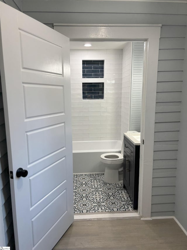 bathroom with hardwood / wood-style floors, vanity, and toilet