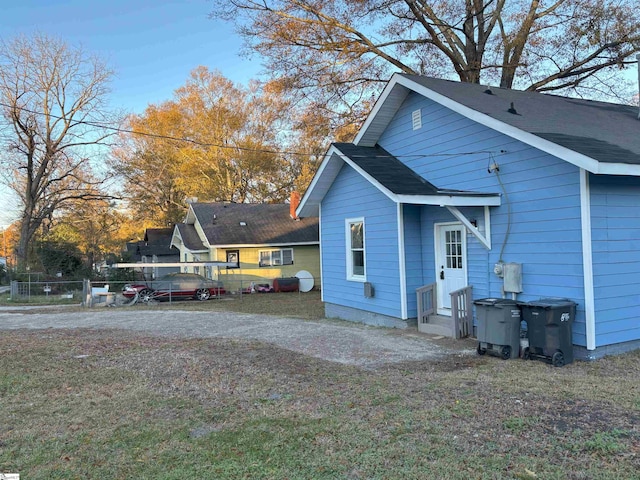 view of side of property with a yard