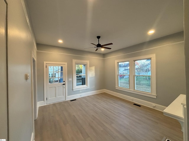 foyer entrance with hardwood / wood-style flooring and ceiling fan