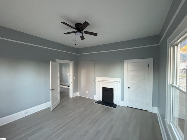 unfurnished living room featuring hardwood / wood-style floors and ceiling fan