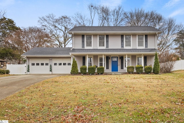 view of property featuring a garage and a front lawn