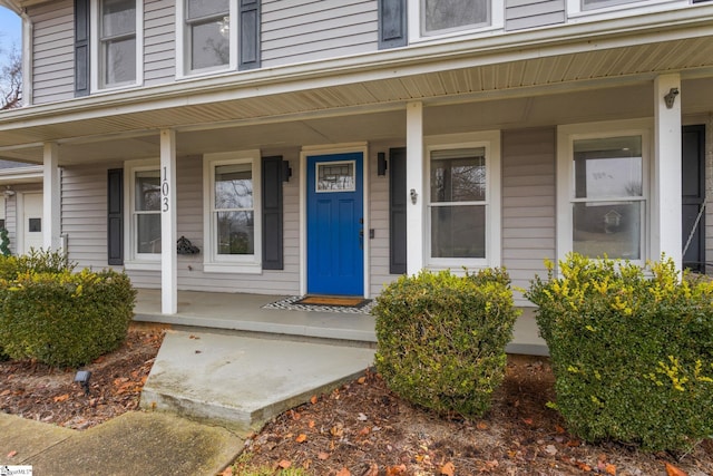 view of exterior entry with covered porch