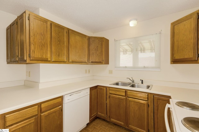 kitchen with dishwasher, stove, dark parquet floors, sink, and a textured ceiling