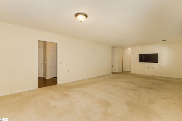 unfurnished living room featuring carpet flooring