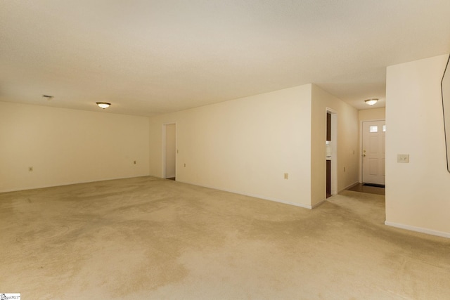 empty room featuring light carpet