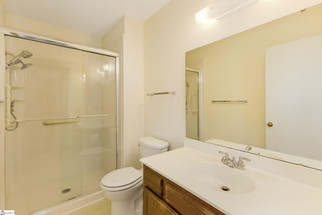 bathroom with vanity, toilet, and a shower with shower door