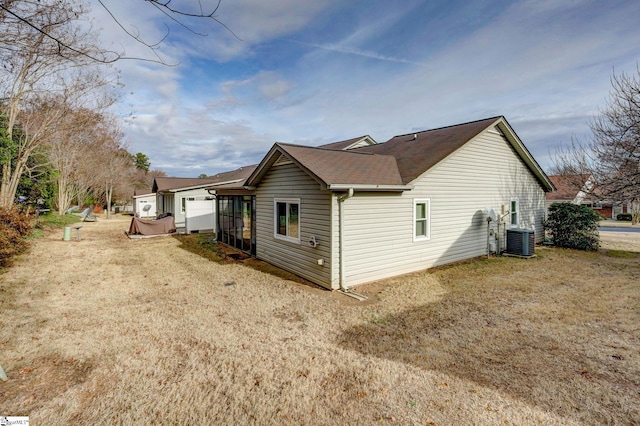 view of side of property featuring central air condition unit and a sunroom