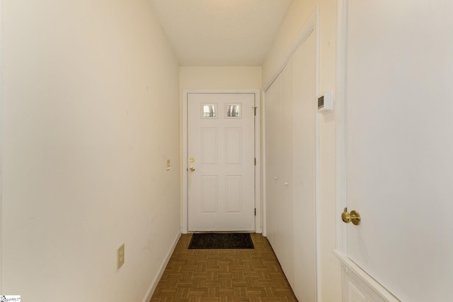 entryway featuring dark parquet flooring