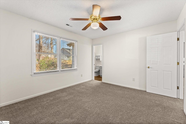 unfurnished bedroom featuring visible vents, baseboards, carpet, and a textured ceiling