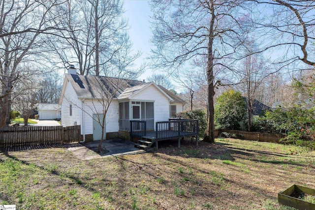 back of property with a patio area, fence, a chimney, and a wooden deck