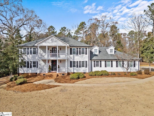 view of front facade featuring covered porch and a balcony