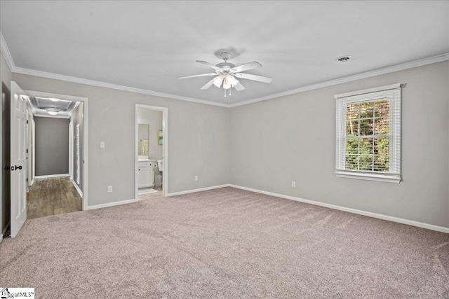 unfurnished bedroom with ensuite bath, ceiling fan, carpet, and ornamental molding