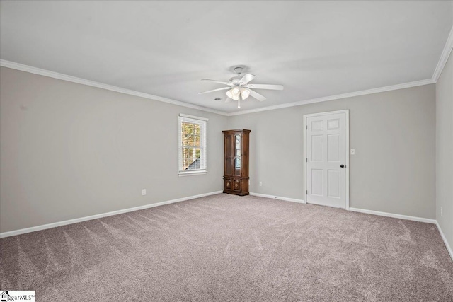 carpeted empty room featuring ceiling fan and ornamental molding