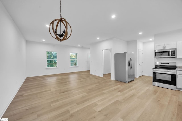 interior space featuring a notable chandelier and light wood-type flooring