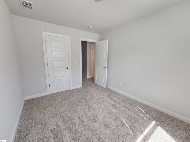 unfurnished bedroom featuring a closet and carpet floors