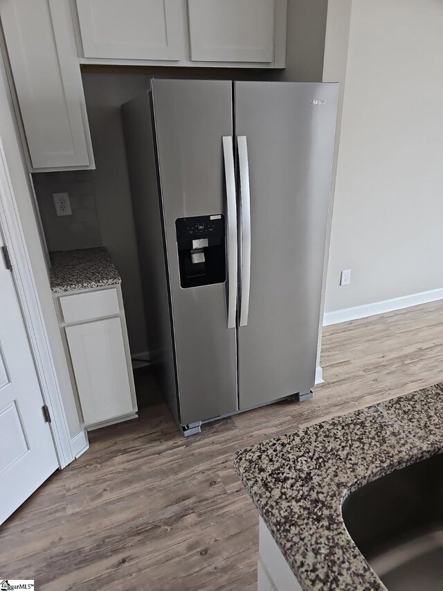 111 Telford Dr, Greenville, SC 29617 - kitchen with stainless steel fridge, light stone countertops, light hardwood / wood-style floors, and white cabinets