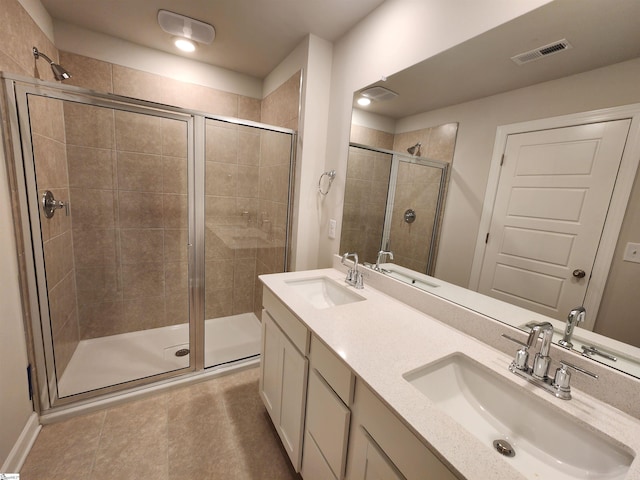 bathroom with tile patterned floors, vanity, and a shower with shower door