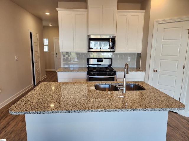 kitchen with stainless steel appliances, white cabinetry, dark wood-type flooring, and sink