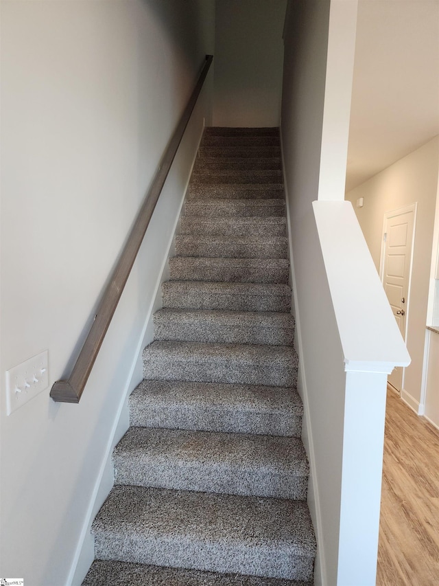 stairs with hardwood / wood-style floors