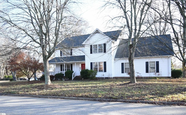 view of front of house with a front yard and covered porch