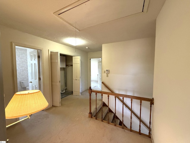 corridor with an upstairs landing and attic access