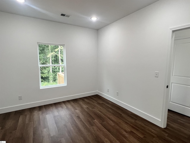 spare room with dark hardwood / wood-style flooring