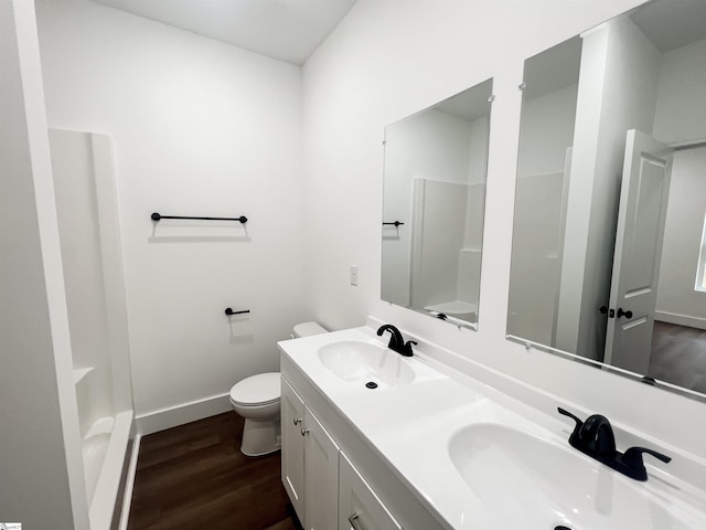 bathroom featuring vanity, wood-type flooring, and toilet