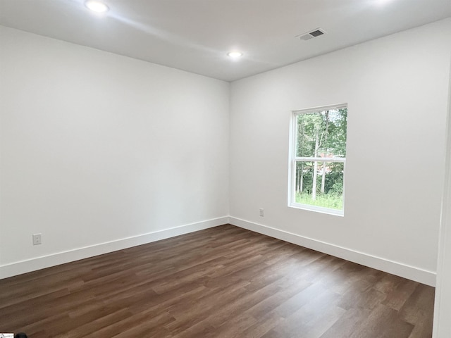 unfurnished room with dark hardwood / wood-style flooring