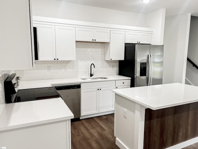 kitchen featuring sink, dark hardwood / wood-style floors, a kitchen island, white cabinetry, and stainless steel appliances