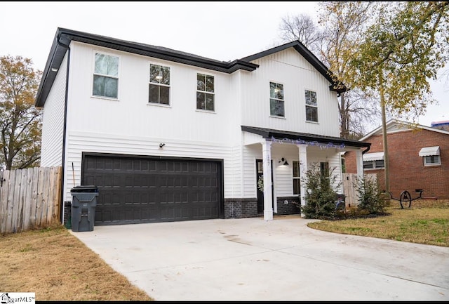 modern inspired farmhouse with covered porch and a garage