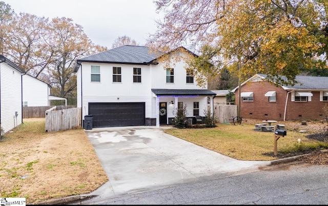 view of front of home with a front yard and a garage