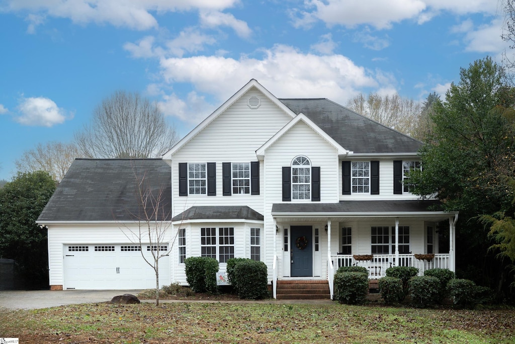 view of front of home with a porch and a garage