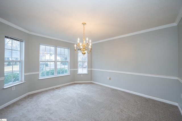 carpeted spare room with ornamental molding and a chandelier