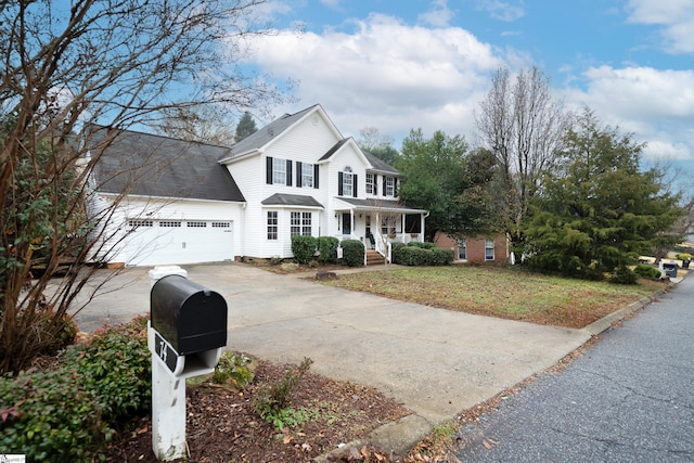 view of front property with covered porch, a front yard, and a garage