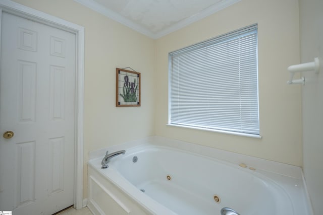 bathroom featuring a bathtub, ornamental molding, and a textured ceiling