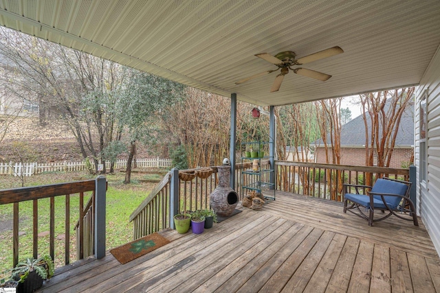 wooden deck with a lawn and ceiling fan