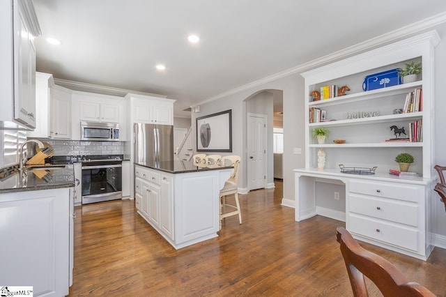 kitchen with white cabinets, dark hardwood / wood-style floors, sink, and stainless steel appliances