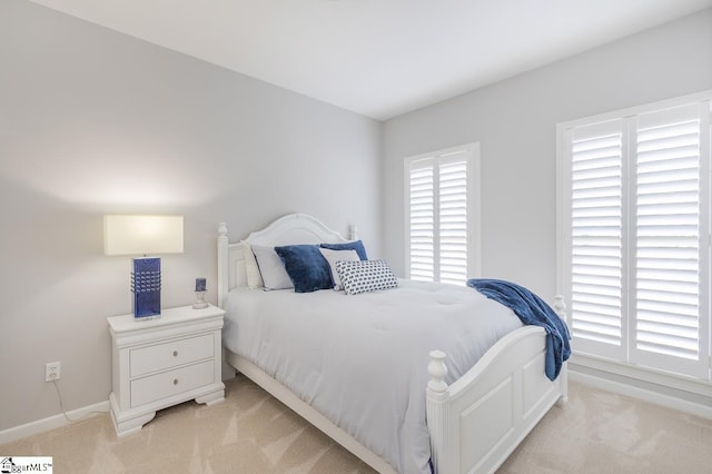 bedroom featuring light colored carpet